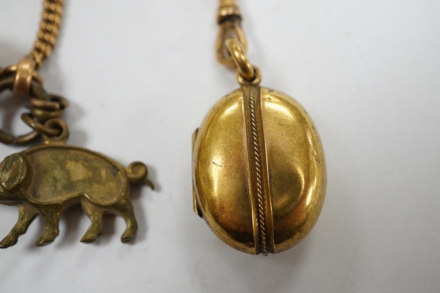 A Victorian yellow metal oval locket, with rope twist band, overall 29mm and a yellow metal fob chain. Condition - fair